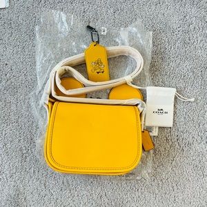 New authentic Coach Disney, Crossbody with Mickey Mouse ears, in banana color.